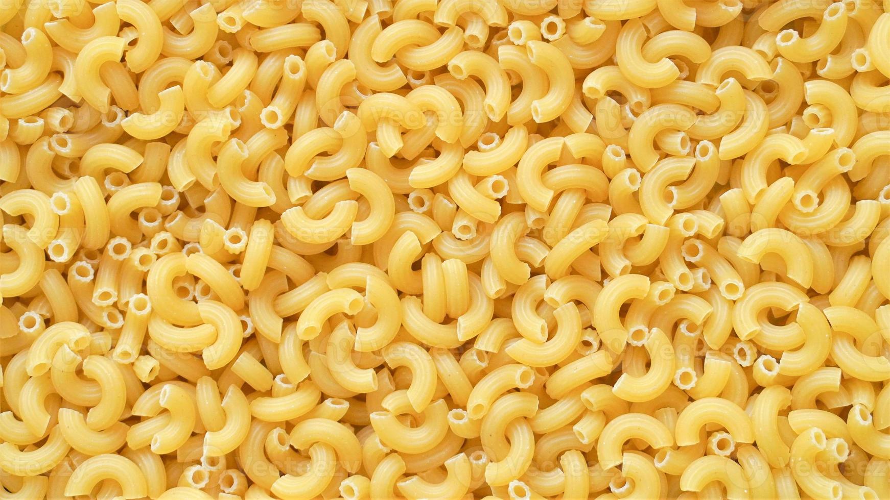 Uncooked elbow macaroni pasta background 16276759 Stock Photo at Vecteezy