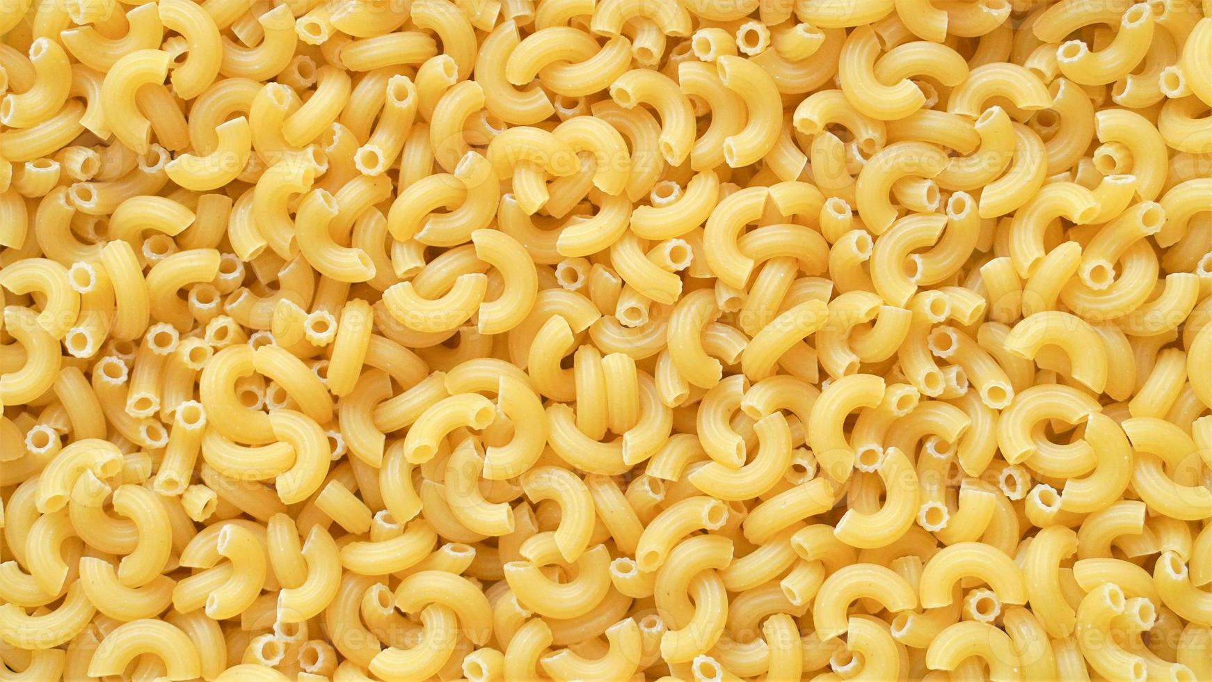 Uncooked elbow macaroni pasta background photo