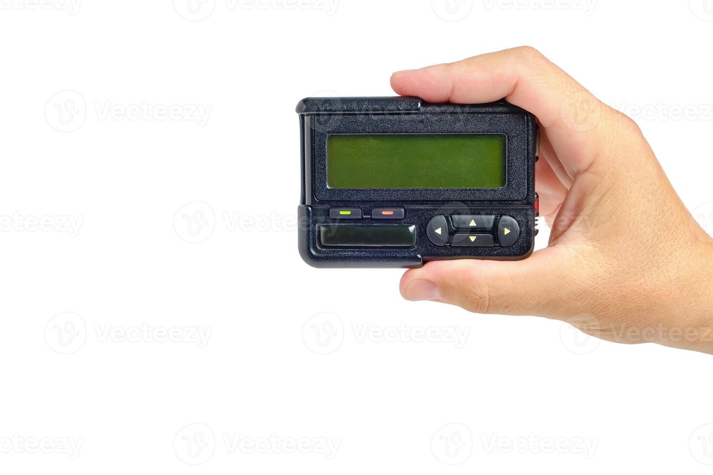 Pager, old retro communication device, in hand on white background