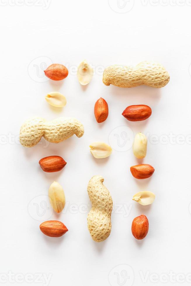 Peanuts isolated on white background. Peeled Peel and Scarlup. photo