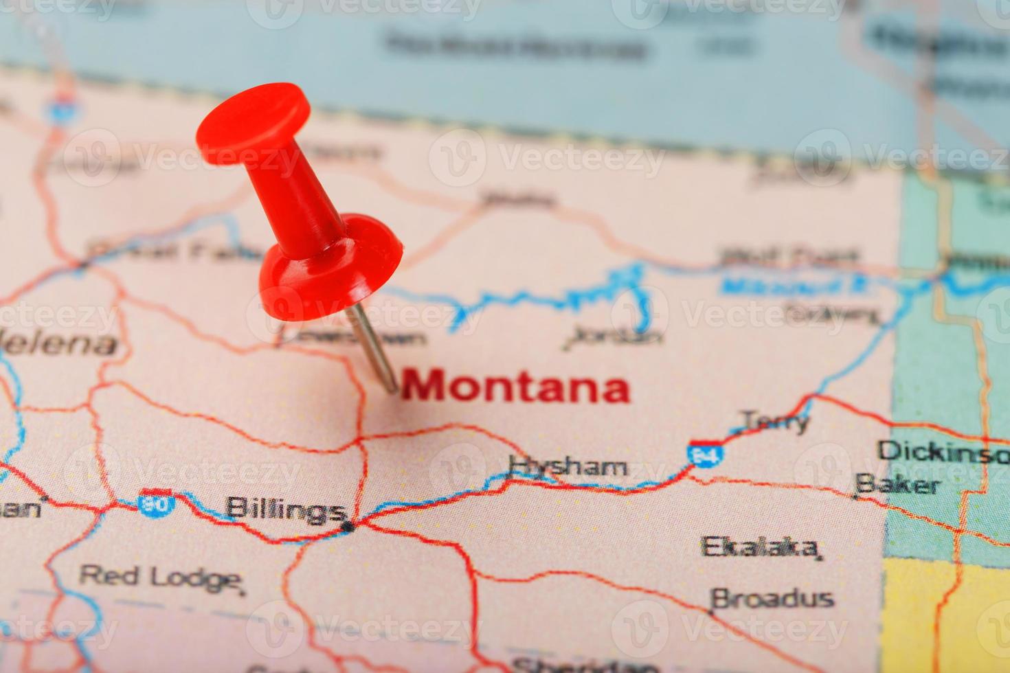 Red clerical needle on a map of USA, Montana and the capital of Helena. Close up Montana map with red tack photo