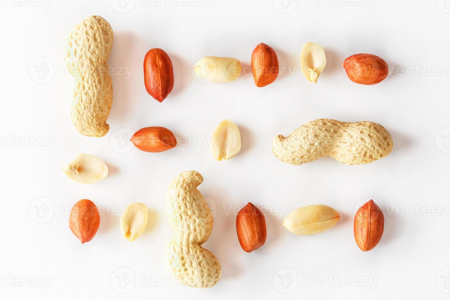 Peanuts isolated on white background. Peeled Peel and Scarlup. photo