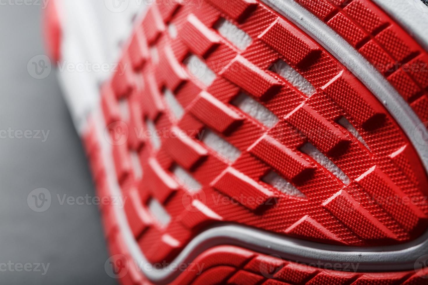 Running shoes with red soles on a black background. photo