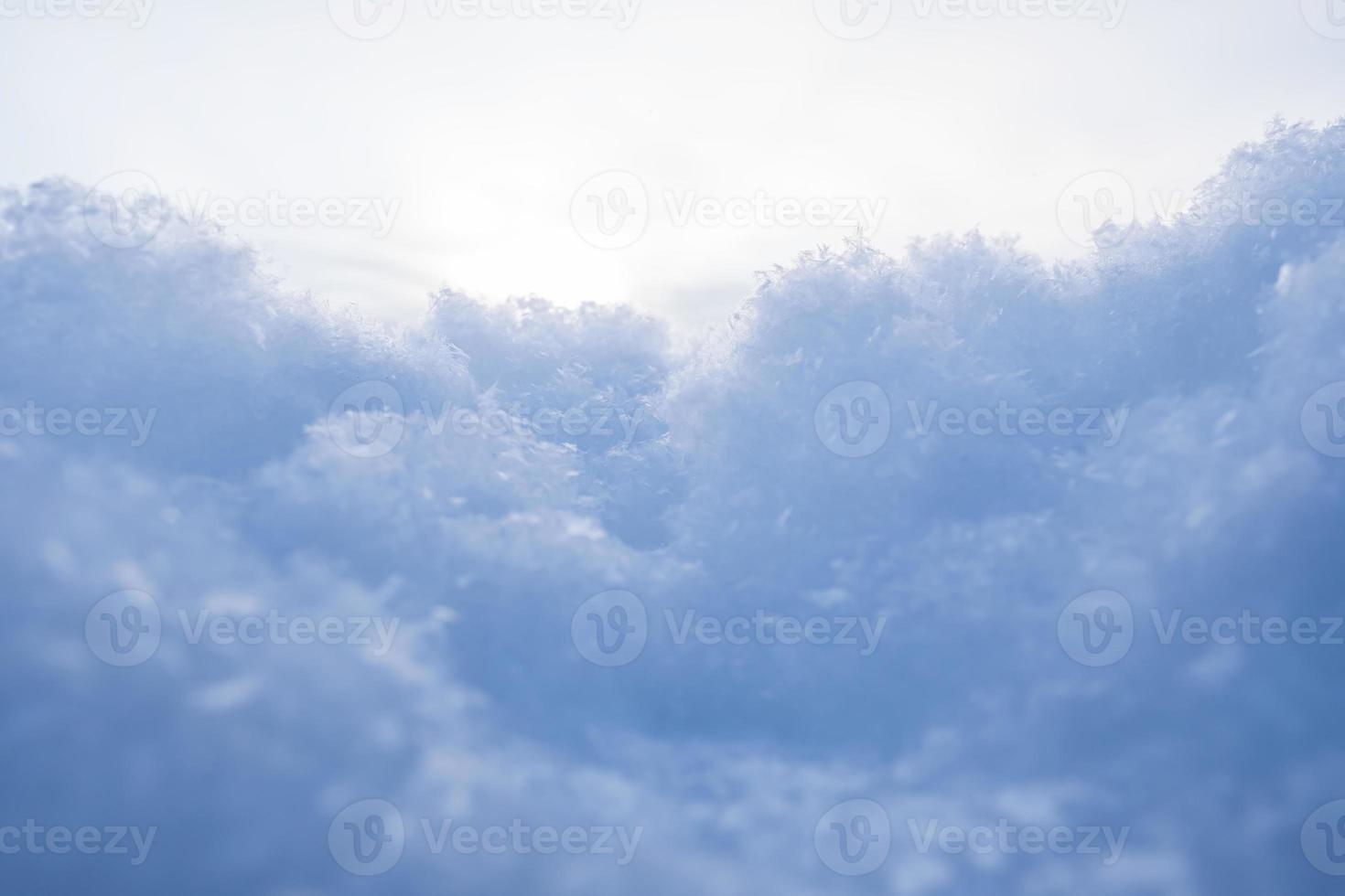 Fluffy snow against the sky, on a winter evening, at sunset. Copy space. Abstract background. Bottom view. photo