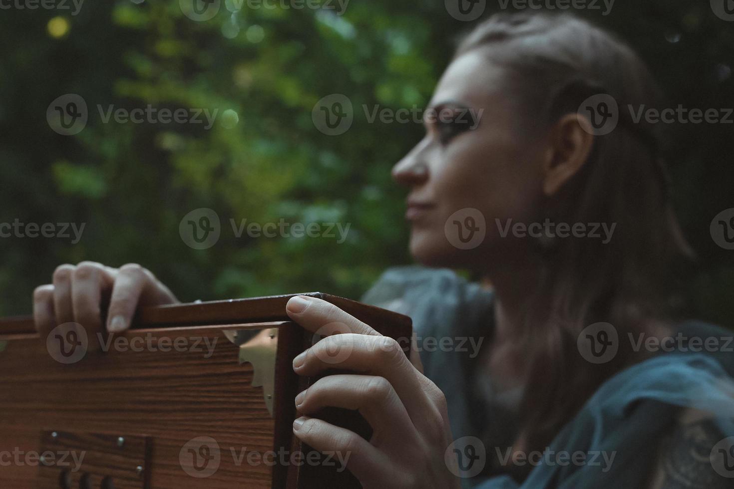 Close up sorceress hands holding wooden box concept photo