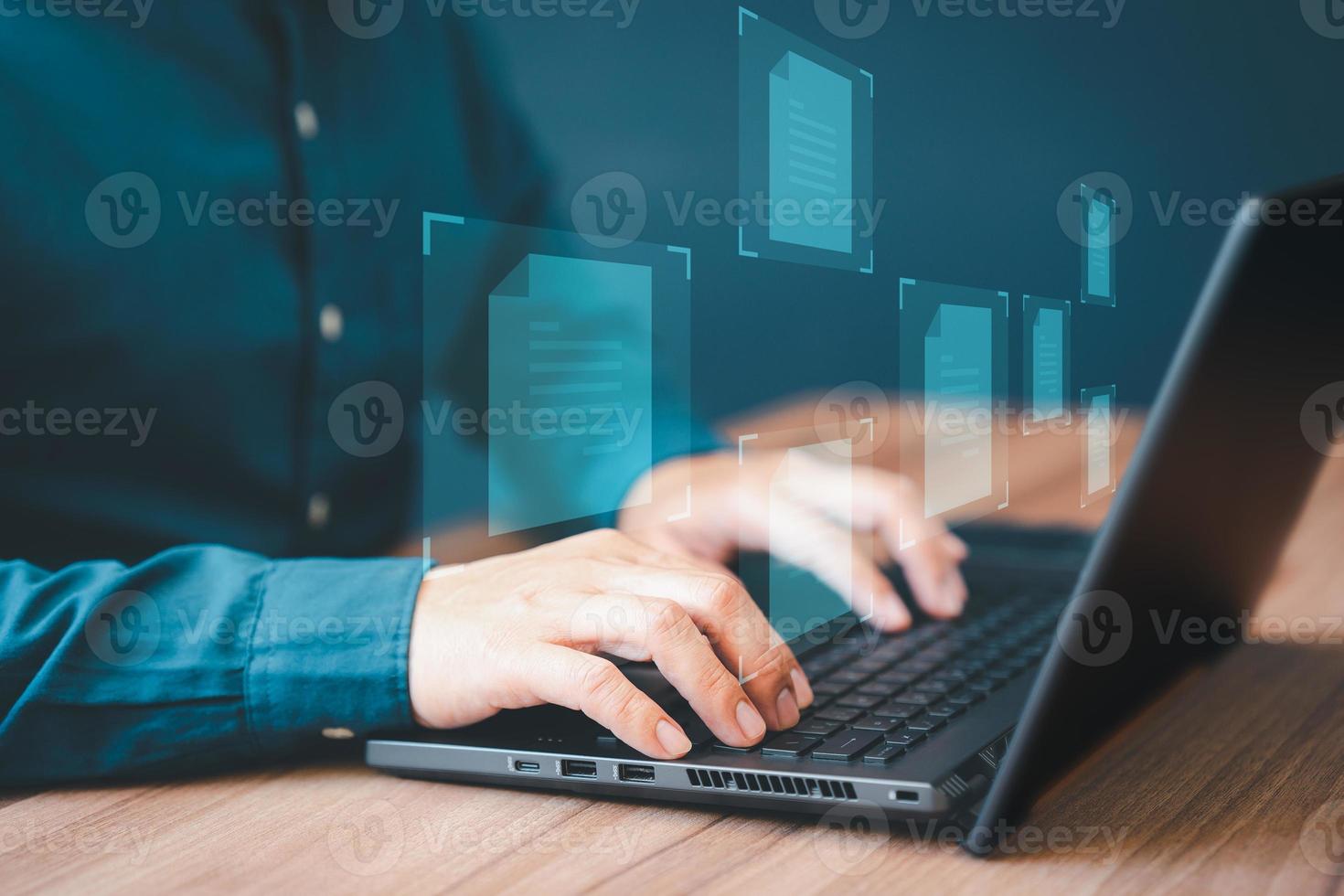 Document Management System, online documentation database and process automation to efficiently manage files. Corporate business technology. Employee man using a computer laptop in office. photo