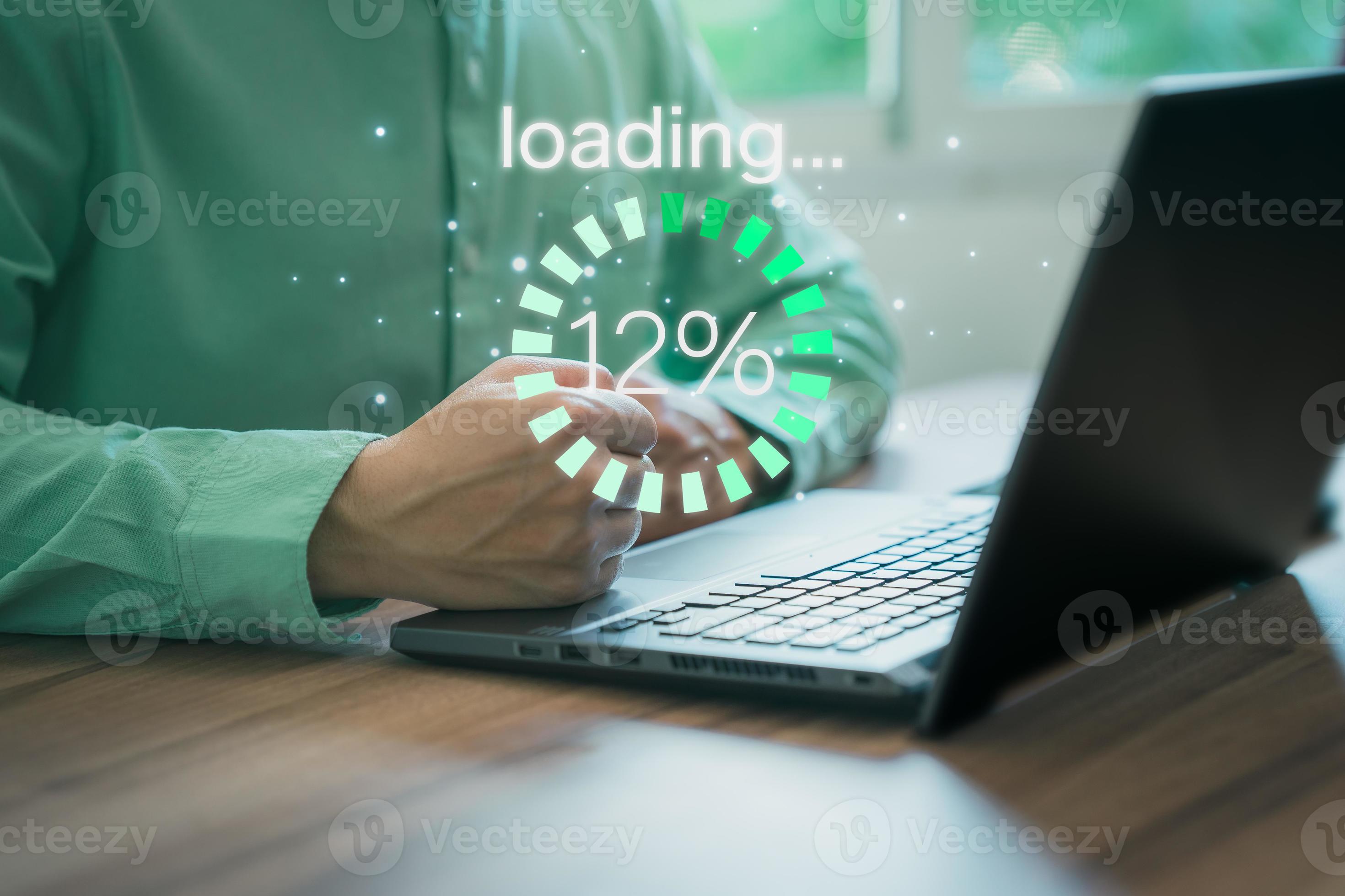 Businessman using a computer laptop to download and waiting to loading ...