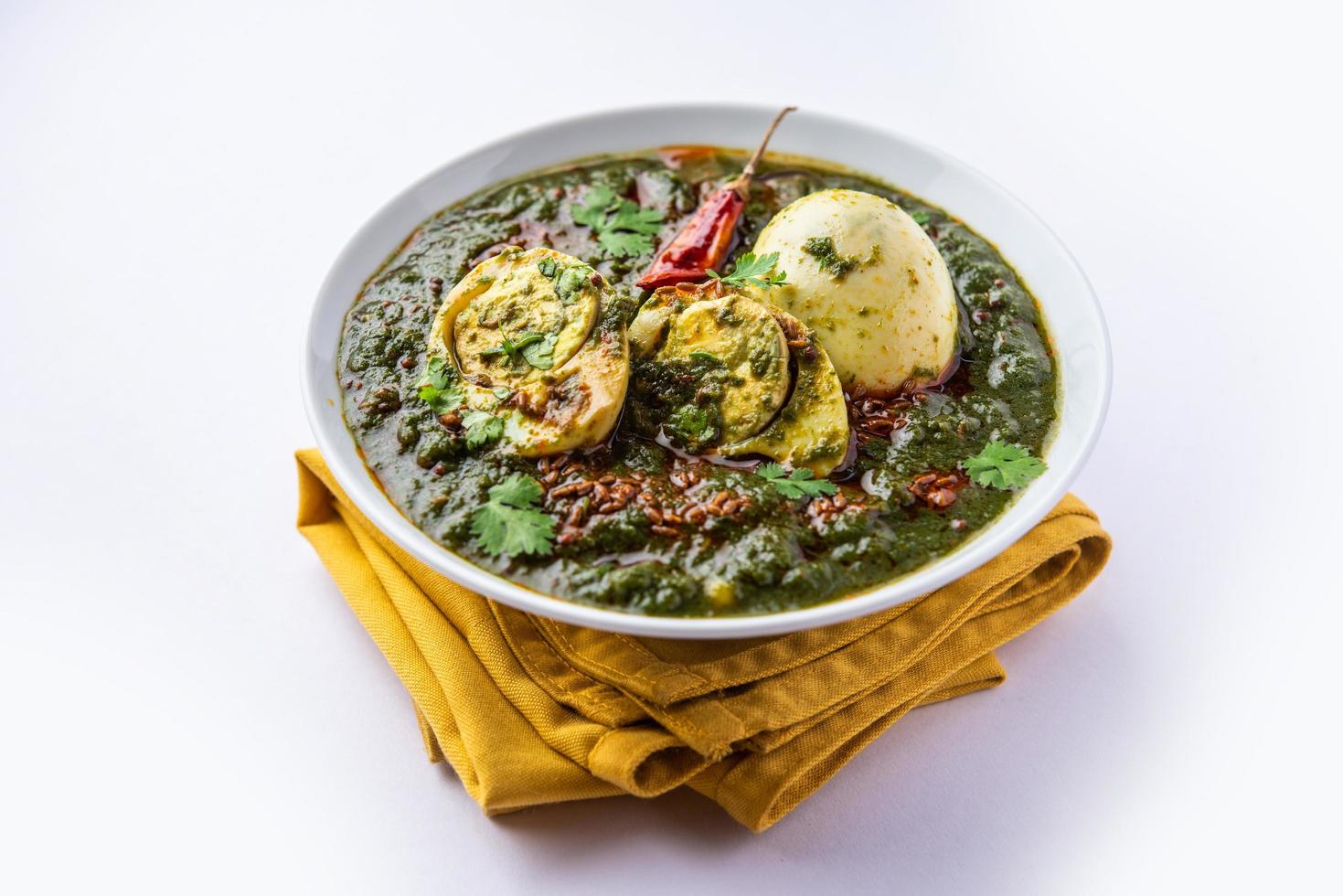 Spinach egg curry is an Indian non vegetarian dish made using palak gravy with eggs photo