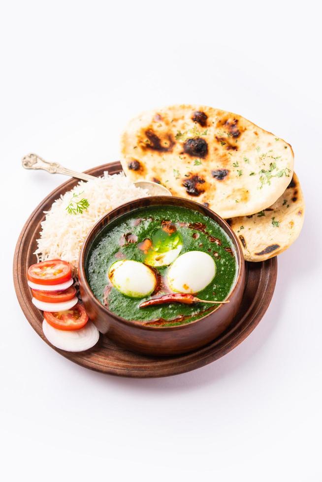 Spinach egg curry is an Indian non vegetarian dish made using palak gravy with eggs photo