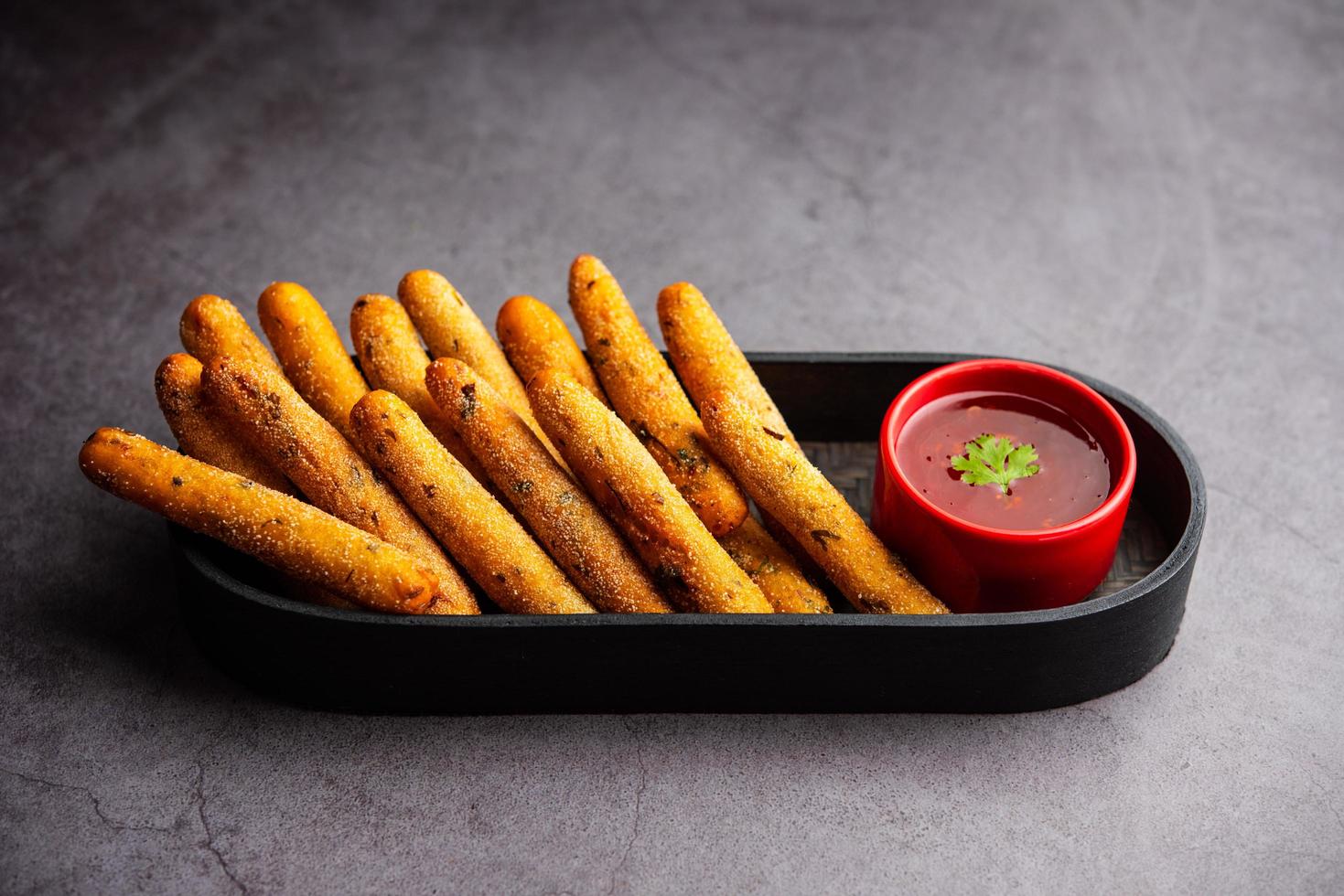 crispy Rava Aloo fingers or Potato semolina fried finger sticks served with ketchup photo