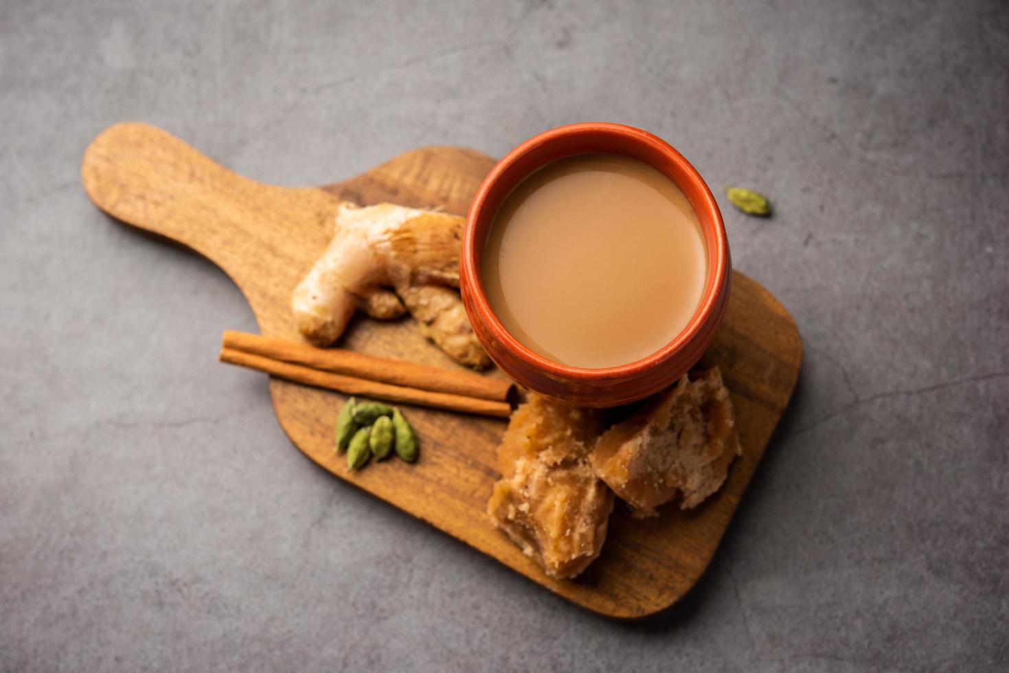 Jaggery tea or Gur ki chai with ingredients like gud, ginger or adrak, green cardamom and cinnamon photo