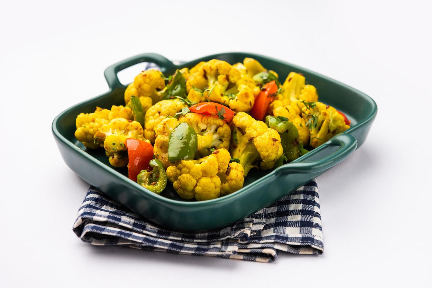 Indian phool Gobi Shimla Mirch Sabji Recipe or Capsicum Cauliflower Sabzi, a healthy and homemade dry vegetable dish. photo