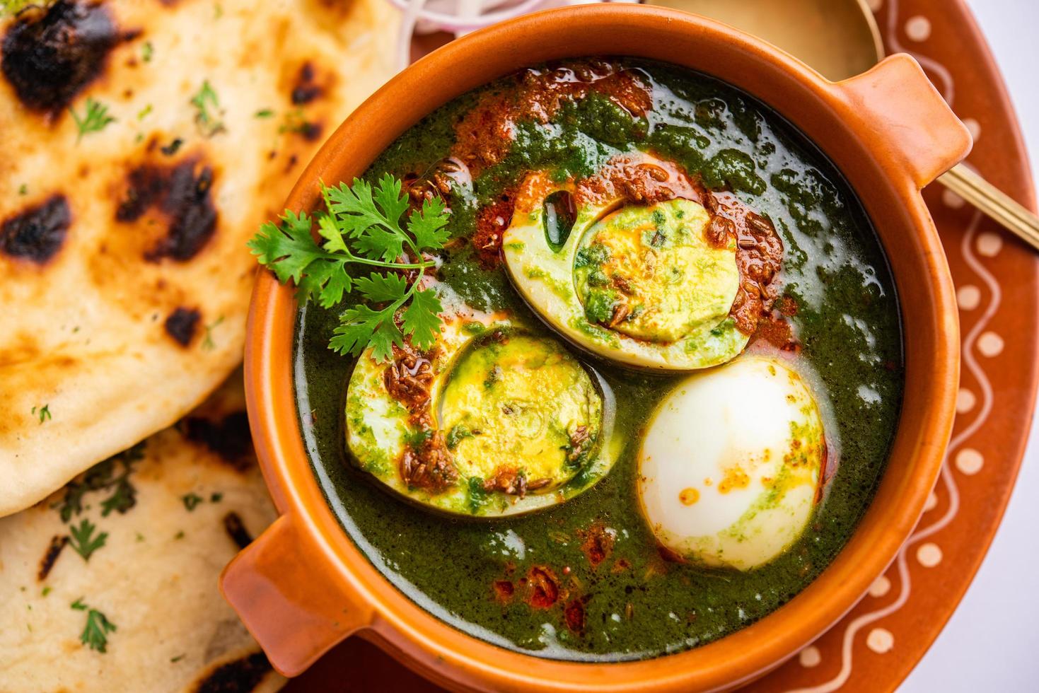Spinach egg curry is an Indian non vegetarian dish made using palak gravy with eggs photo