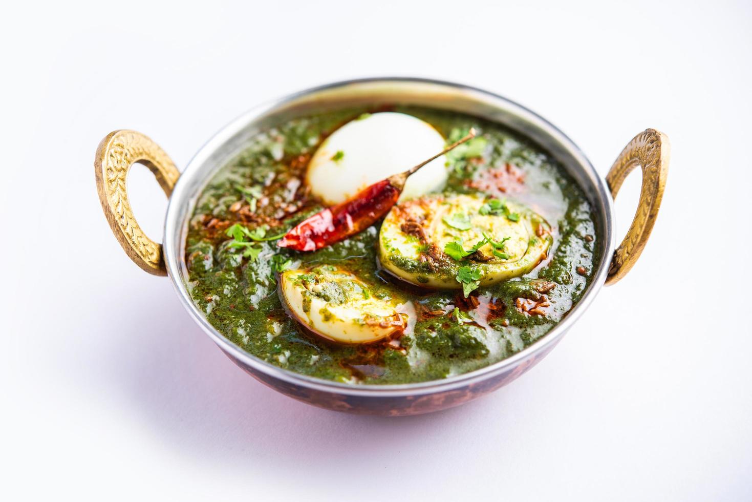 Spinach egg curry is an Indian non vegetarian dish made using palak gravy with eggs photo