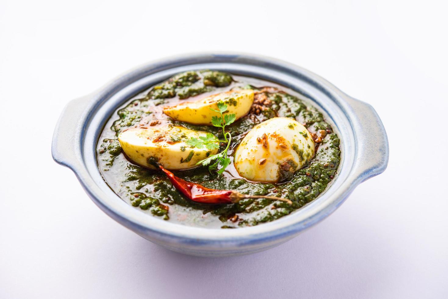 Spinach egg curry is an Indian non vegetarian dish made using palak gravy with eggs photo