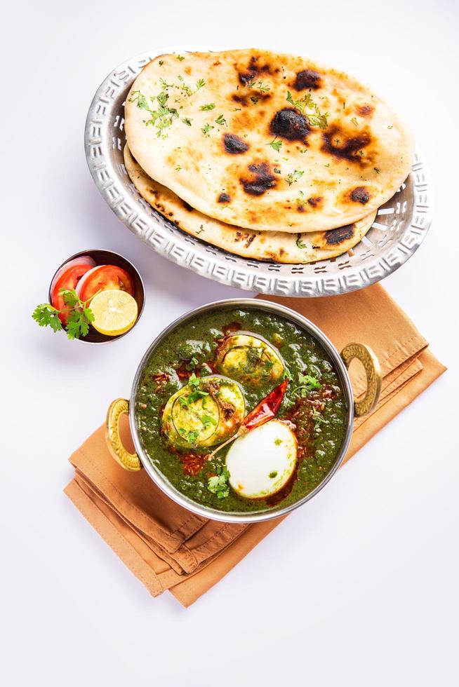 Spinach egg curry is an Indian non vegetarian dish made using palak gravy with eggs photo