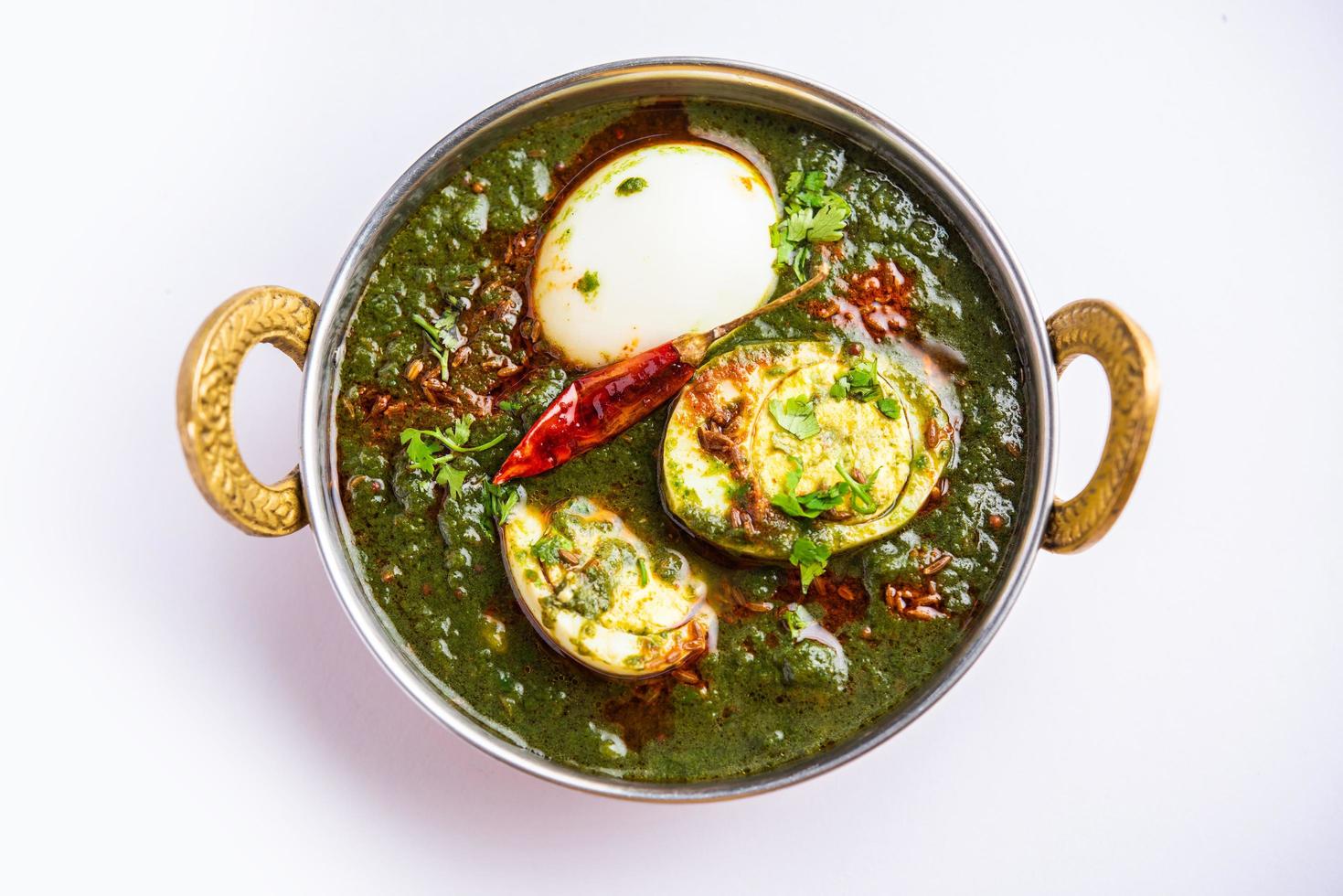 Spinach egg curry is an Indian non vegetarian dish made using palak gravy with eggs photo