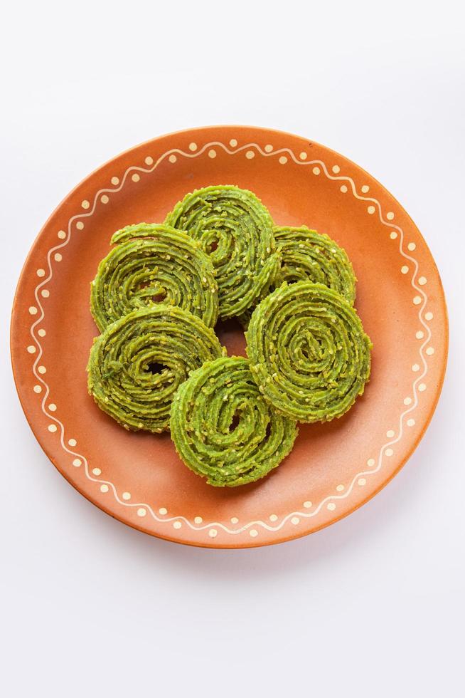 Palak Chakli or Spinach Murukku, healthy Indian festival or tea time snack photo