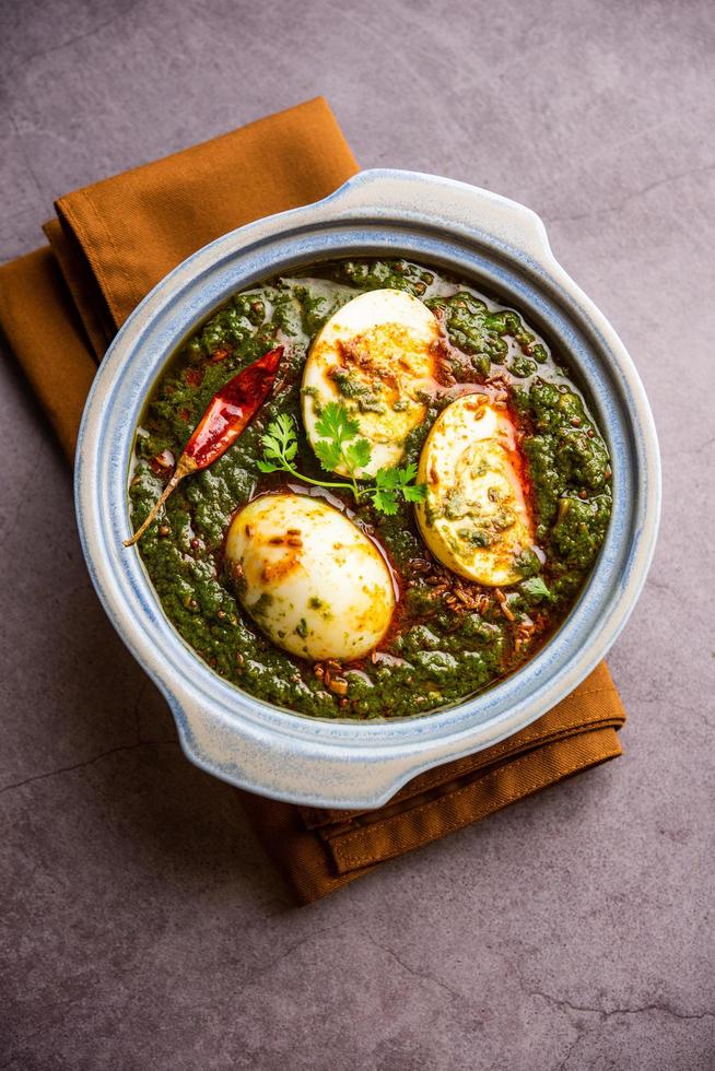 Spinach egg curry is an Indian non vegetarian dish made using palak gravy with eggs photo