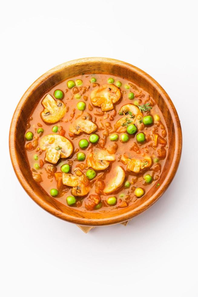 Mushroom and Pea Curry with Roasted Garlic, Indian food served in a bowl photo