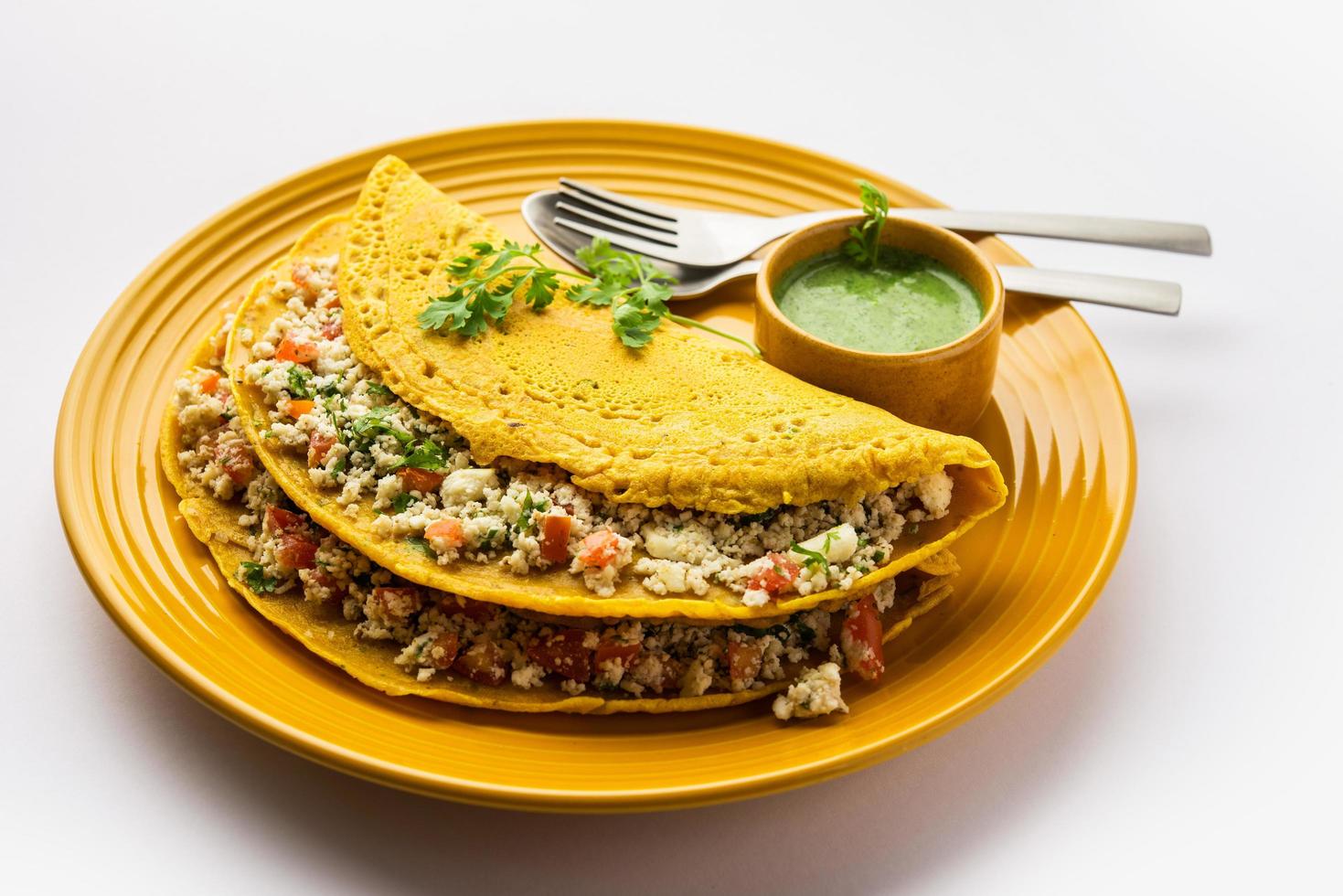 Paneer stuffed Besan chilla or Cheela made using chickpea flour with cottage cheese stuffing photo