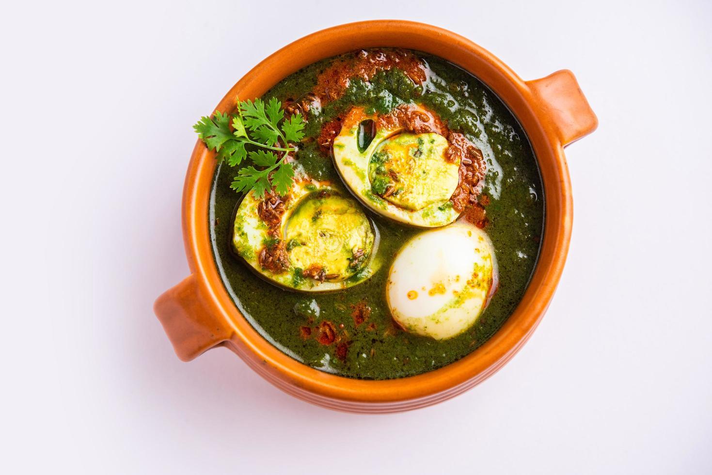 Spinach egg curry is an Indian non vegetarian dish made using palak gravy with eggs photo