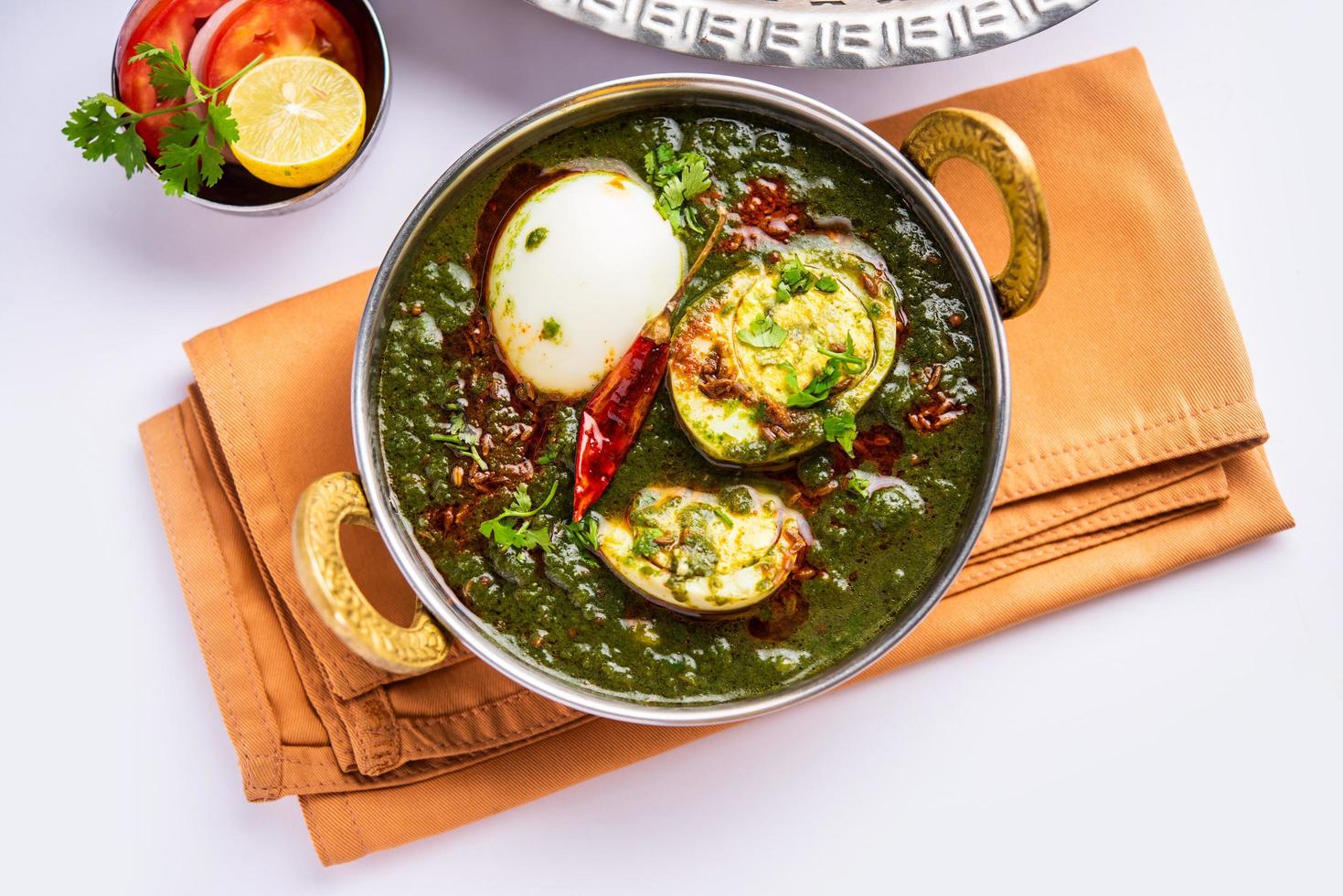 Spinach egg curry is an Indian non vegetarian dish made using palak gravy with eggs photo