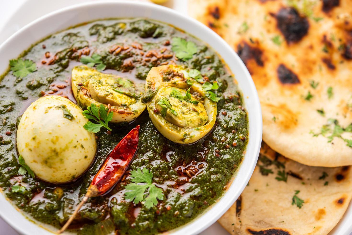 Spinach egg curry is an Indian non vegetarian dish made using palak gravy with eggs photo