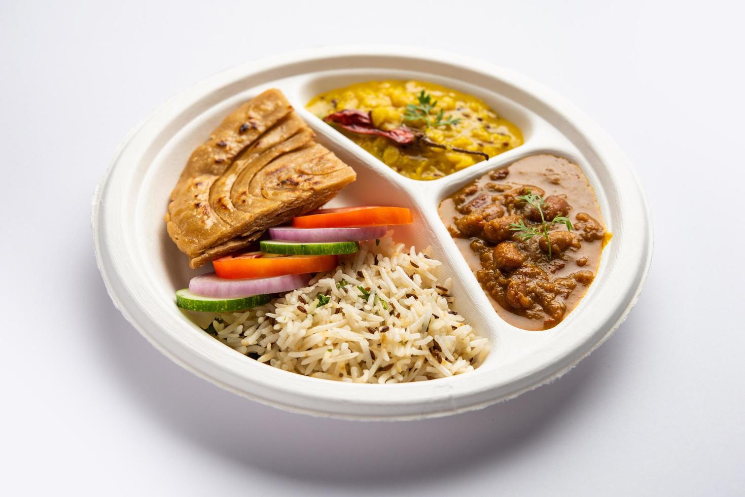 Indian mini meal parcel platter, combo thali with Rajma Masala, roti, dal tadka, jeera rice, salad photo