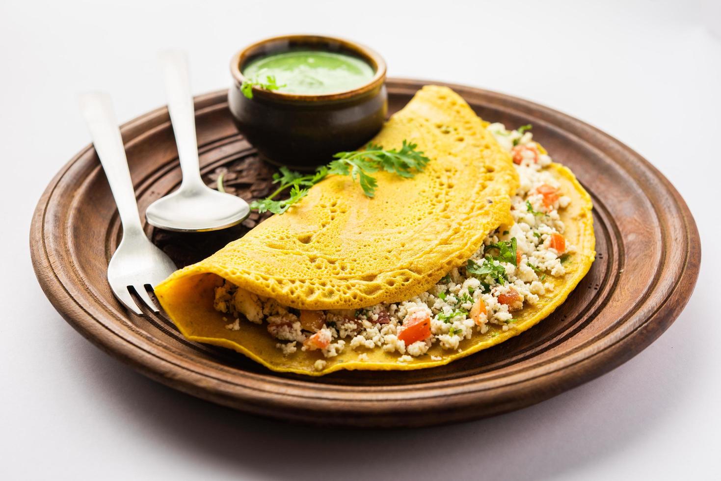 Paneer stuffed Besan chilla or Cheela made using chickpea flour with cottage cheese stuffing photo