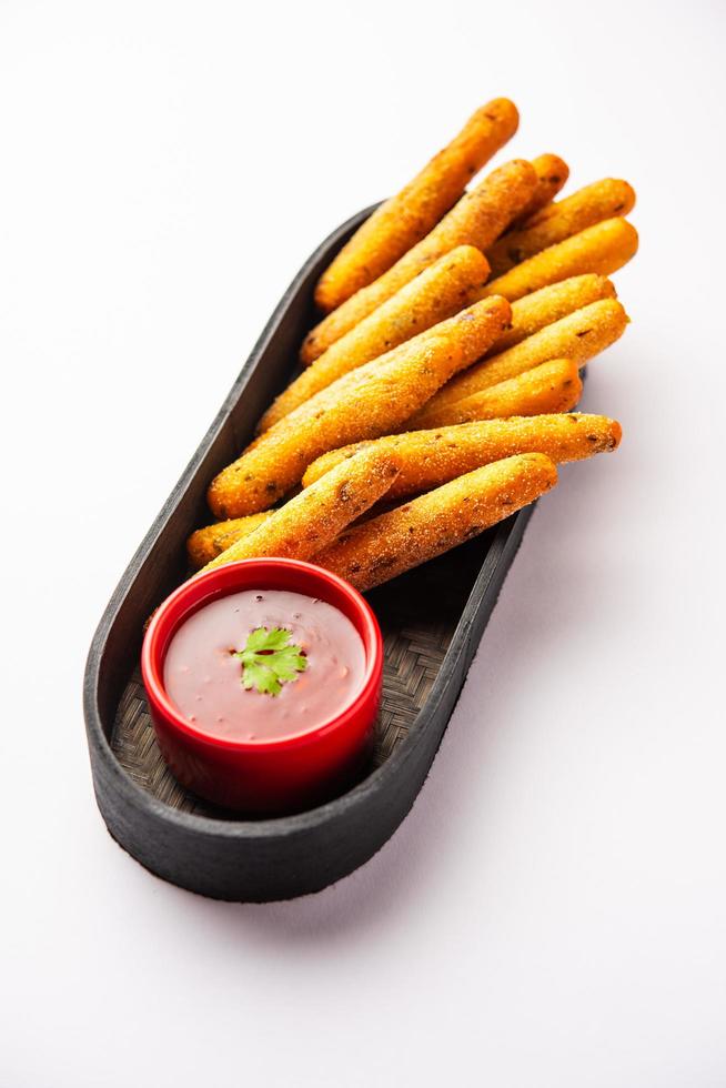 crispy Rava Aloo fingers or Potato semolina fried finger sticks served with ketchup photo