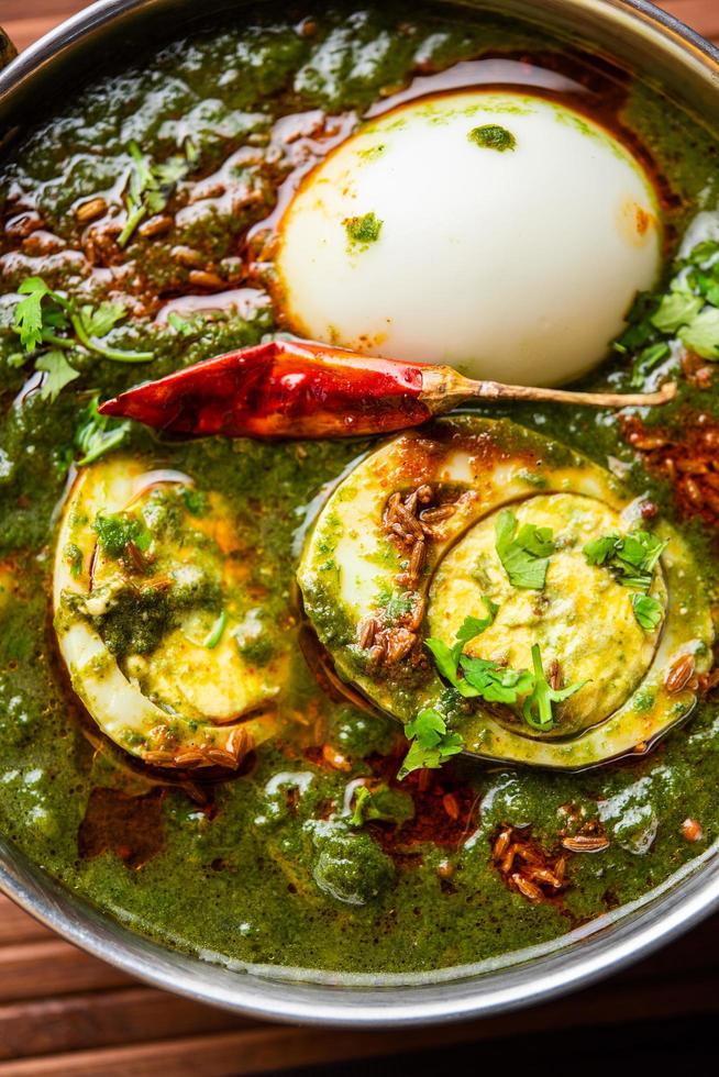 Spinach egg curry is an Indian non vegetarian dish made using palak gravy with eggs photo