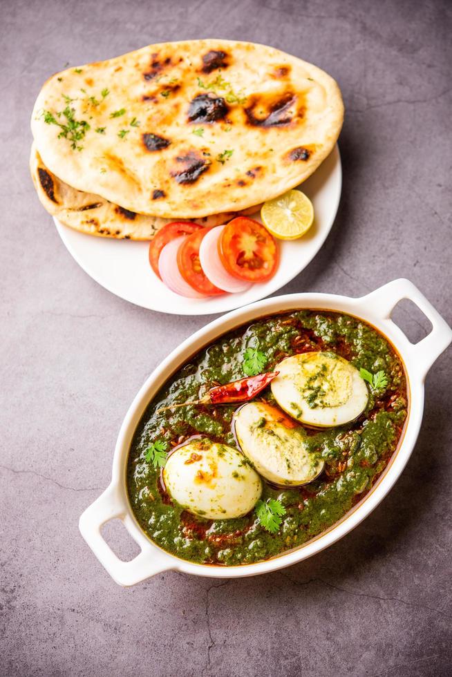 Spinach egg curry is an Indian non vegetarian dish made using palak gravy with eggs photo