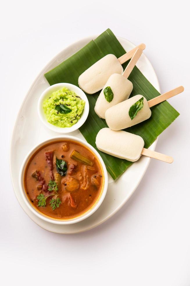 Idly lollipop or idli candy with stick served with sambar and chutney,South indian breakfast photo