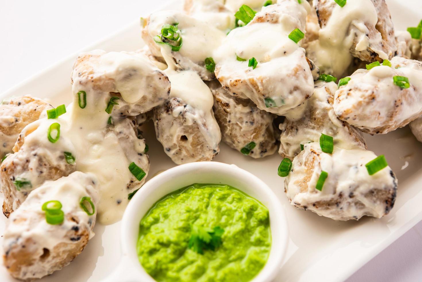 vegetarian soya malai chaap made using soya chaap with white creamy gravy photo