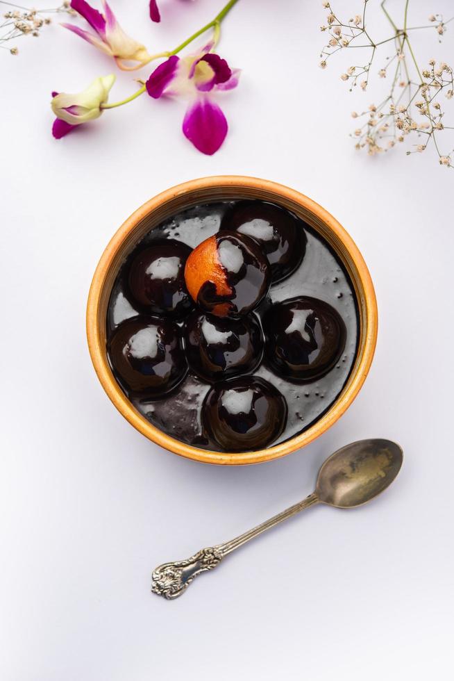 Chocolate dipped gulab jamun, indian creative fusion dessert food photo