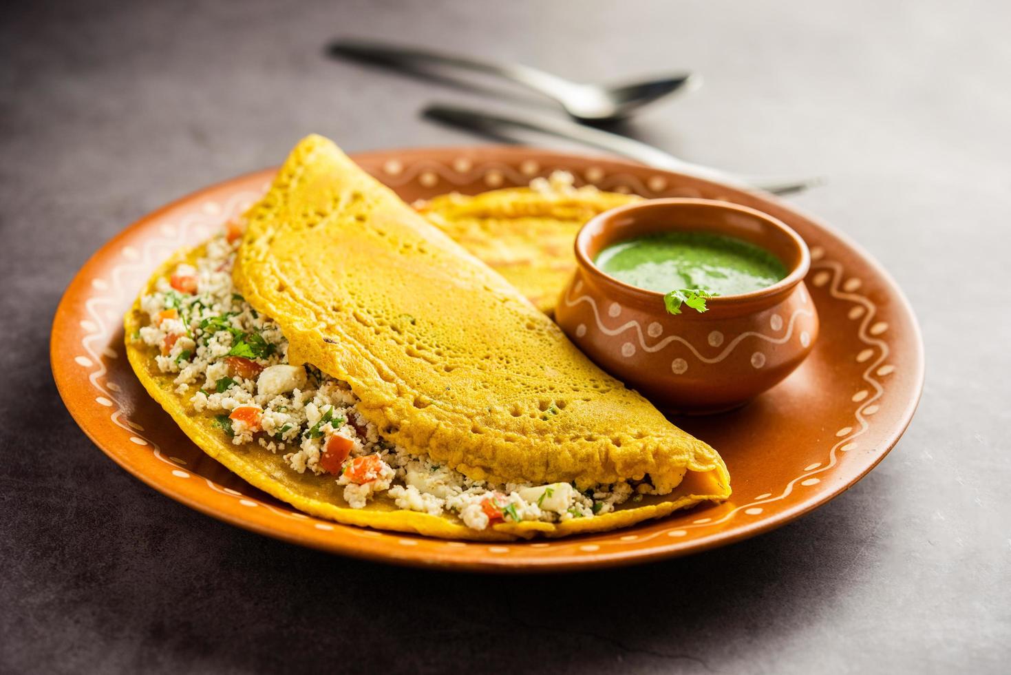 Paneer stuffed Besan chilla or Cheela made using chickpea flour with cottage cheese stuffing photo