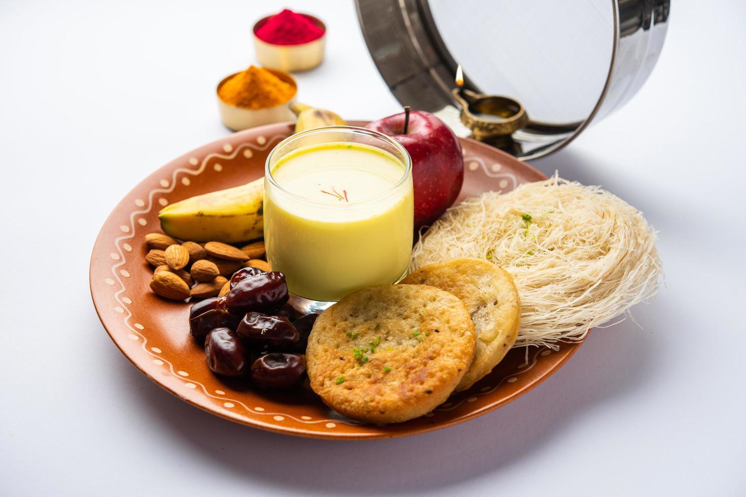 Sargi - pre-dawn meal for karwa chauth or karva chauth puja served with Chalni or strainer and diya photo