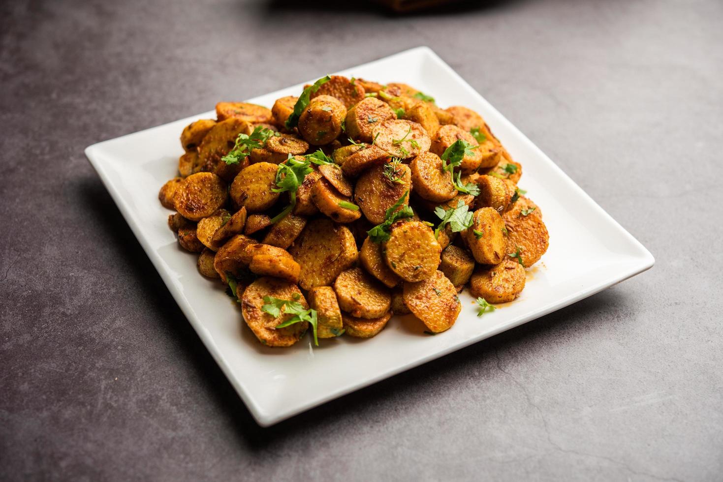 Stir fried taro roots. Arbi ki sabji, ghuiya masala curry Sabzi or arvi dum Masala. Garnished with coriander photo