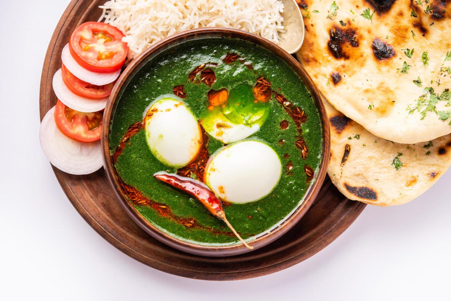 Spinach egg curry is an Indian non vegetarian dish made using palak gravy with eggs photo