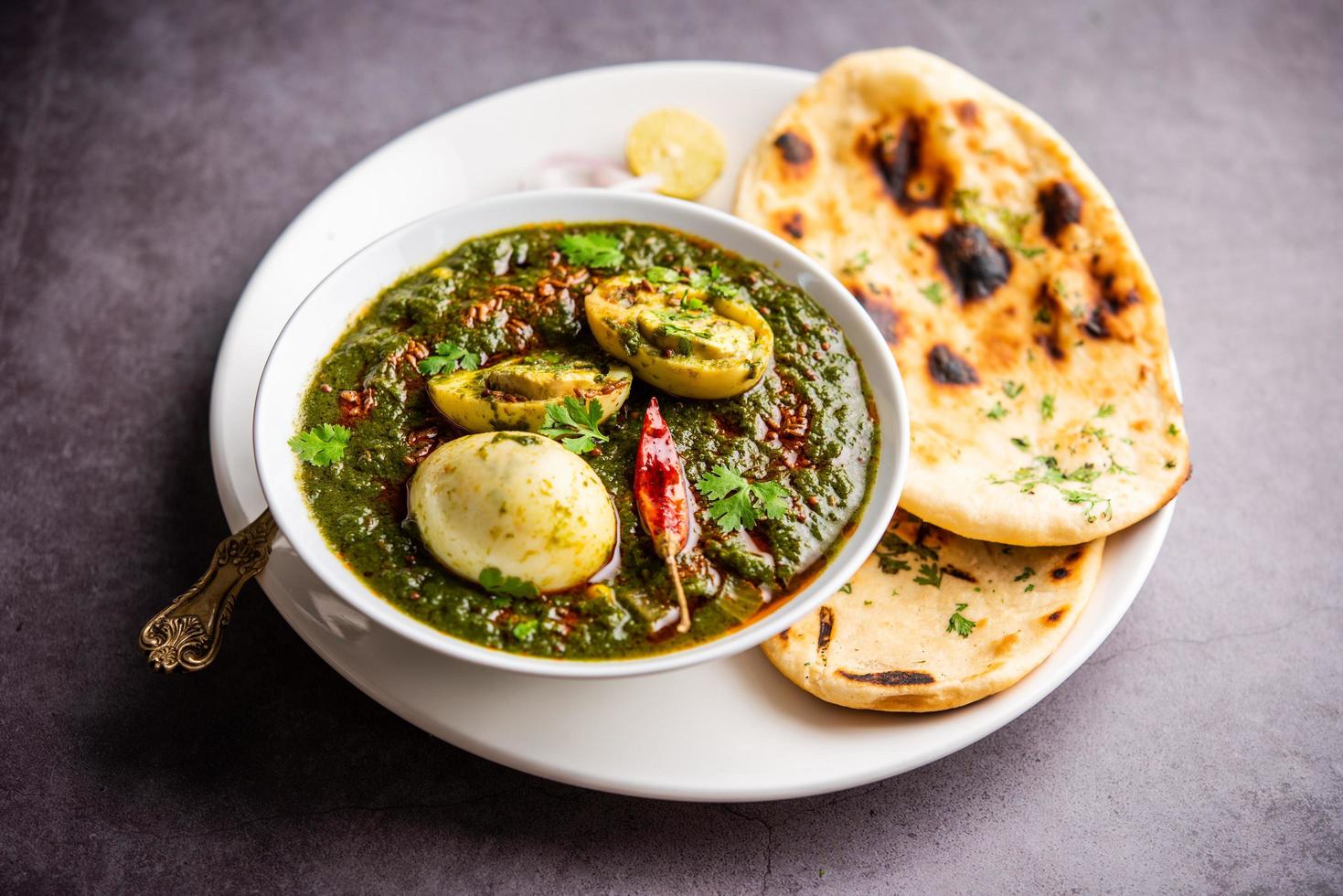 Spinach egg curry is an Indian non vegetarian dish made using palak gravy with eggs photo