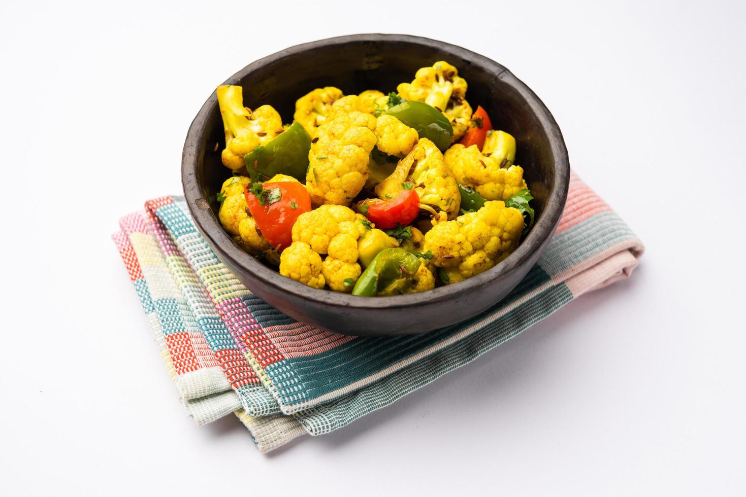 Indian phool Gobi Shimla Mirch Sabji Recipe or Capsicum Cauliflower Sabzi, a healthy and homemade dry vegetable dish. photo