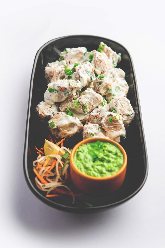 vegetarian soya malai chaap made using soya chaap with white creamy gravy photo