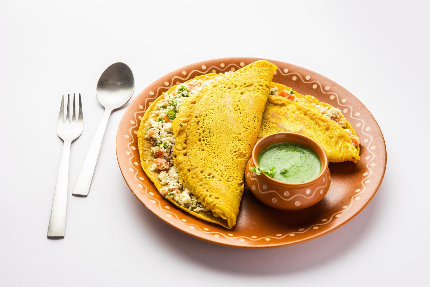Paneer stuffed Besan chilla or Cheela made using chickpea flour with cottage cheese stuffing photo