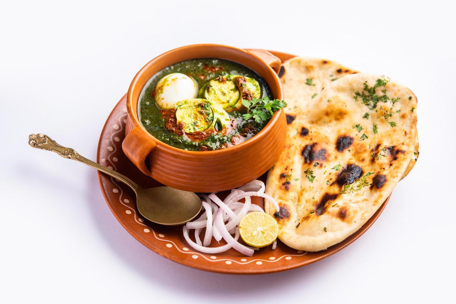 Spinach egg curry is an Indian non vegetarian dish made using palak gravy with eggs photo