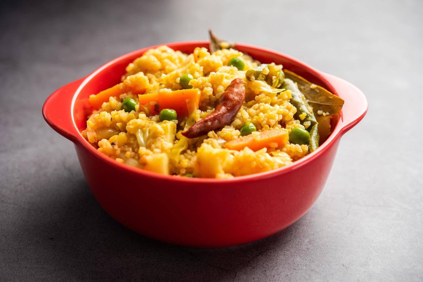 Bengali dish khichdi or khichuri made from a combination of lentils and rice and vegetables photo