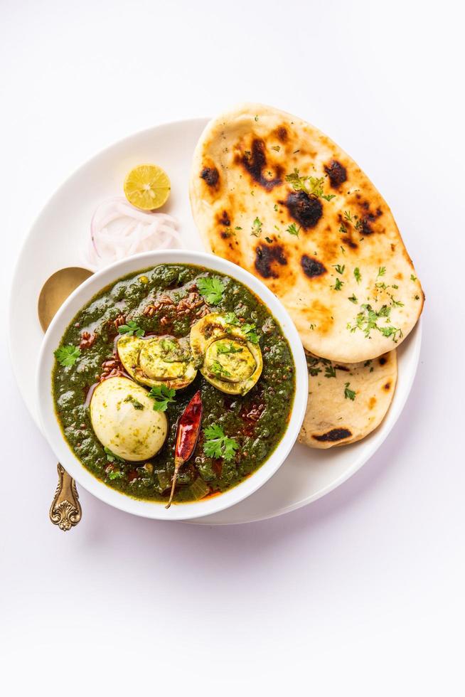 Spinach egg curry is an Indian non vegetarian dish made using palak gravy with eggs photo