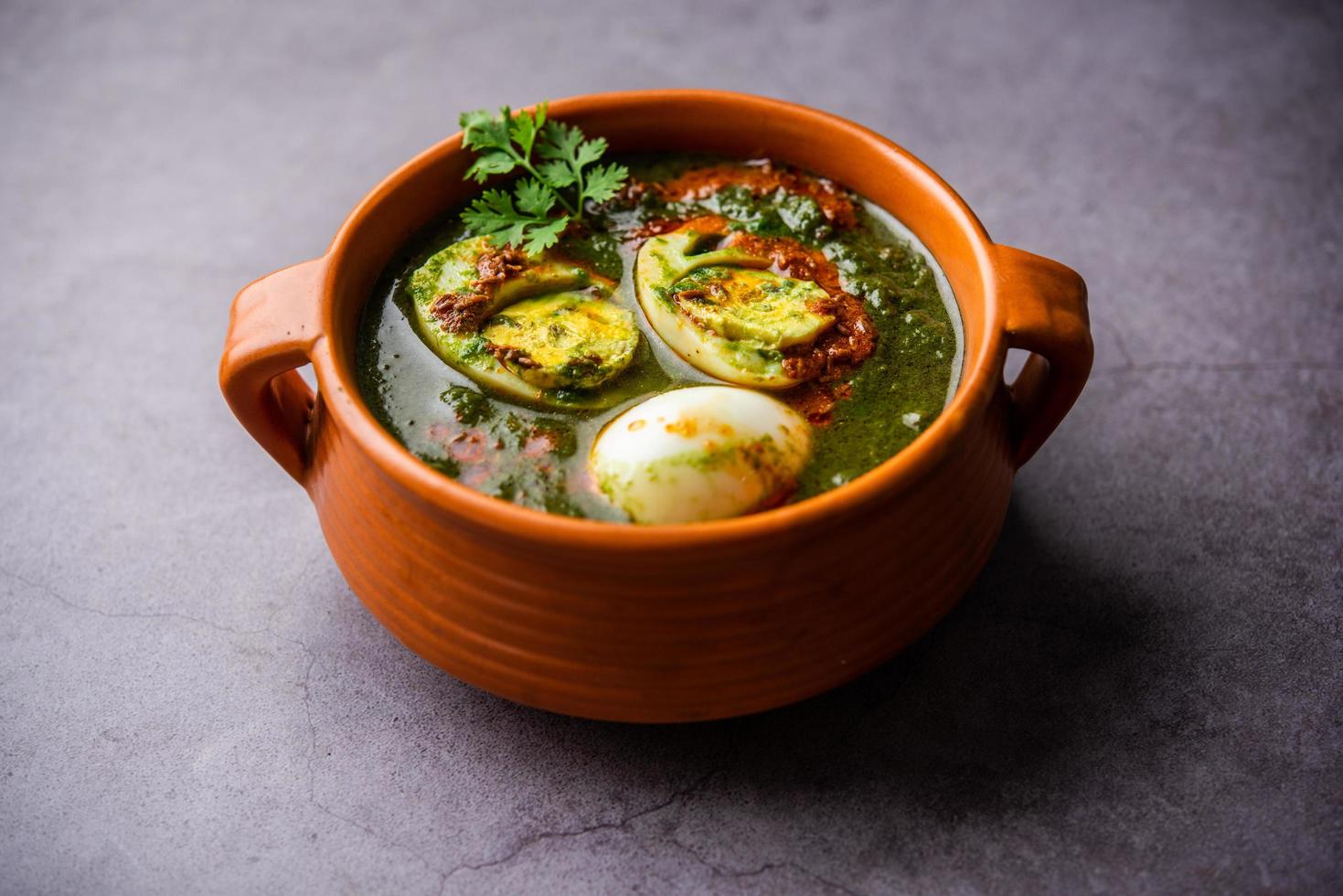 Spinach egg curry is an Indian non vegetarian dish made using palak gravy with eggs photo