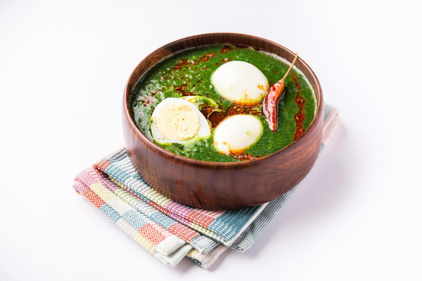 Spinach egg curry is an Indian non vegetarian dish made using palak gravy with eggs photo
