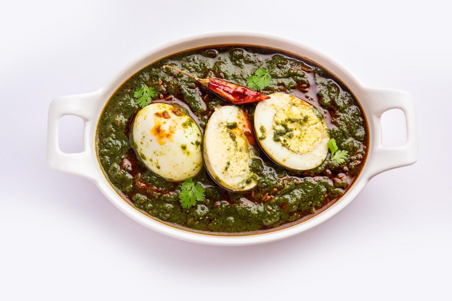 Spinach egg curry is an Indian non vegetarian dish made using palak gravy with eggs photo